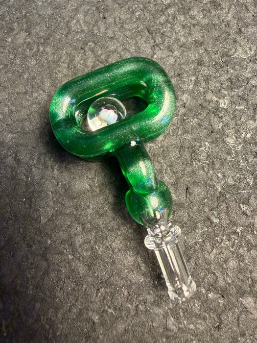 JNG Green Stardust Joylink: a glittering green ring-shaped top with an opal marble held in the middle, on a clear ribbed stem