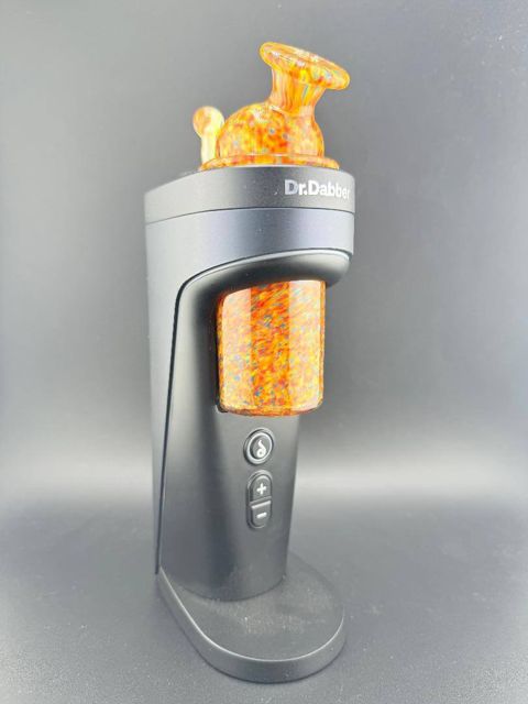 Paulson Pieces set on a Switch 2: an orange confetti glass top and matching joystick cap installed on the rig